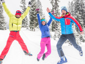 Group of skiers jumping and having fun